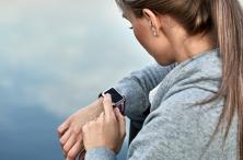 woman looking at smart watch