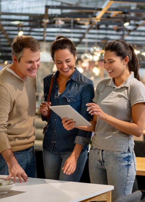 Couple and sales associate looking at iPad