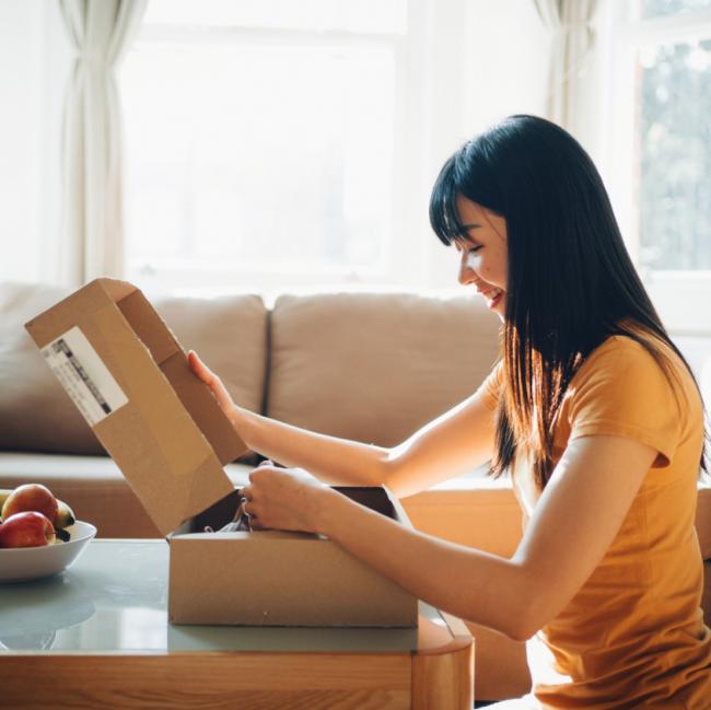 woman opening box